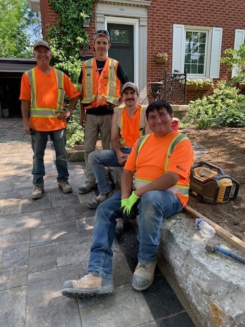 Four Helmutz team members helping implement backyard patio ideas for Waterloo homes.