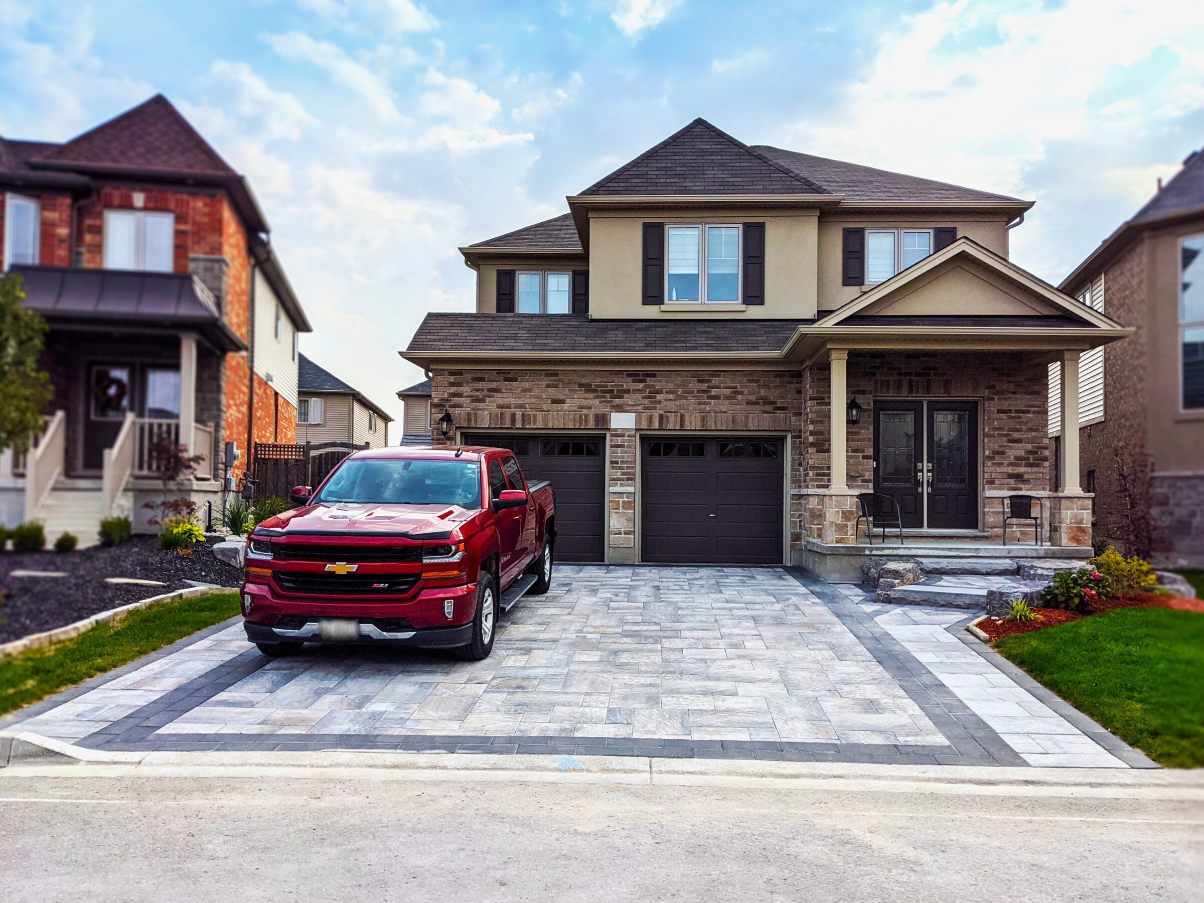 A red car parked outside the home